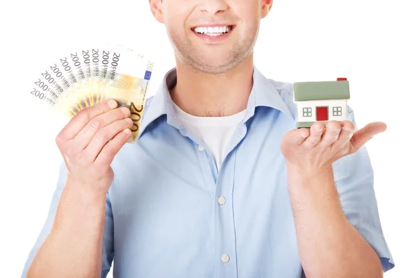 Man with house model and money — Stock Photo, Image