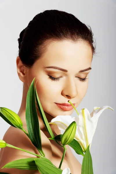 Woman with a lily flower — Stock Photo, Image