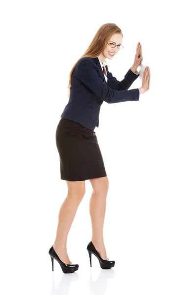 Businesswoman trying to push the wall — Stock Photo, Image