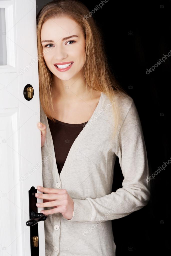 Woman opening her house door