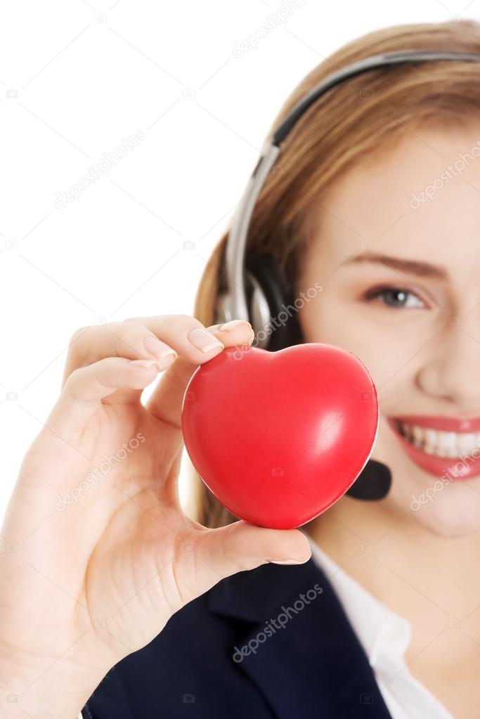 Call center woman holding heart