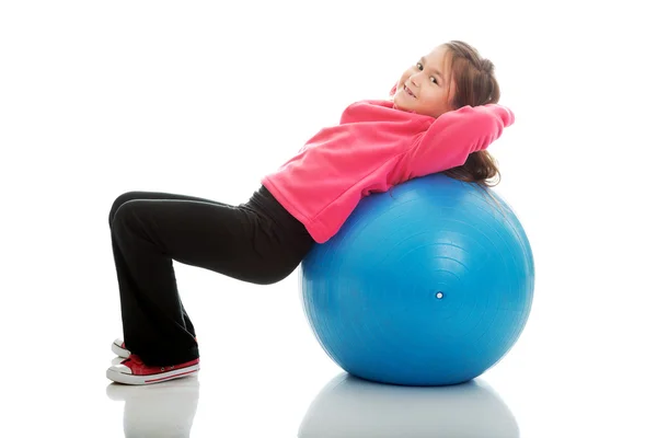 Girl lying on a big ball — Stock Photo, Image