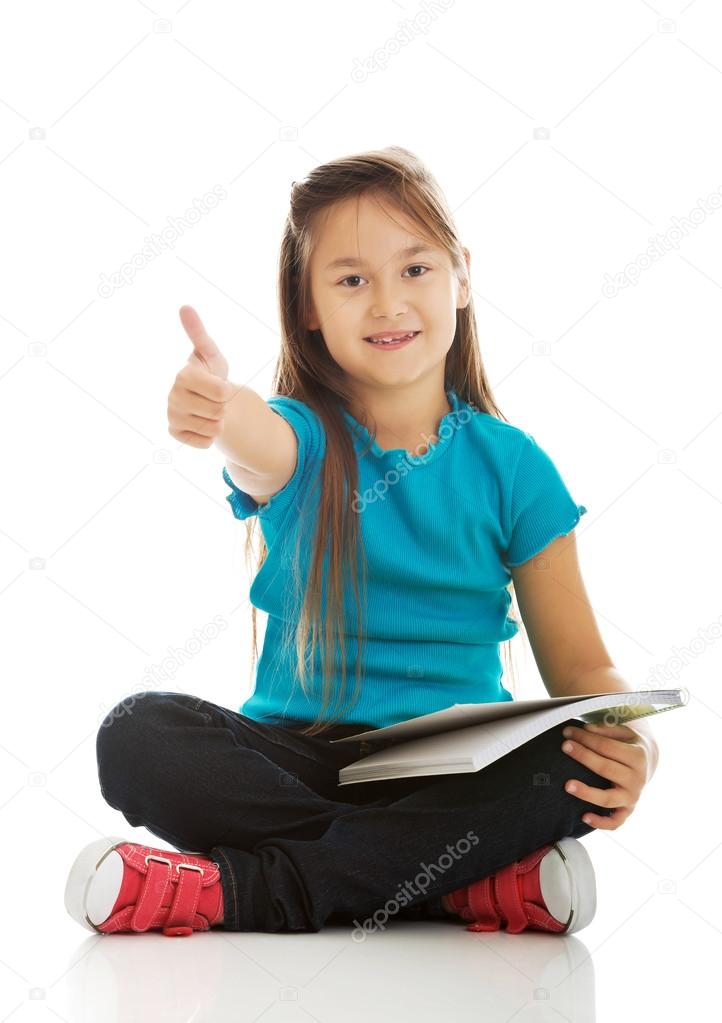 Little girl sitting cross legged and learning Stock Photo by ©piotr
