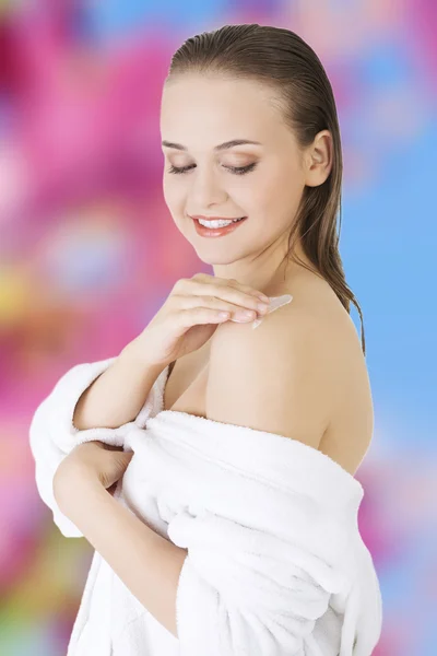 Young woman wearing white bathrobe — Stock Photo, Image