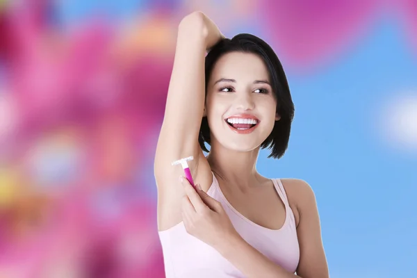 Woman shaving armpit — Stock Photo, Image