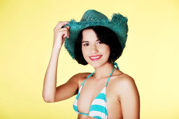 Woman in swimsuit holding a hat — Stock Photo, Image