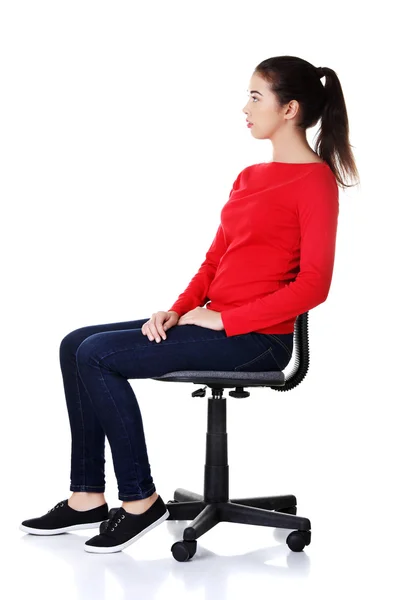 Happy woman sitting on a chair — Stock Photo, Image