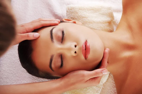 Young woman face massage in spa — Stock Photo, Image