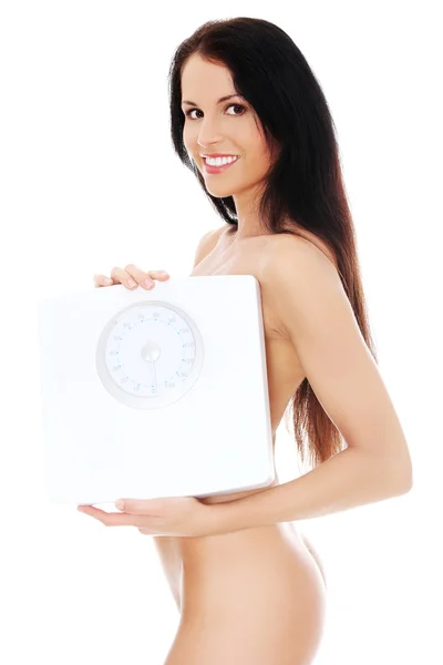 Обнажённая женщина держит весы . — стоковое фото