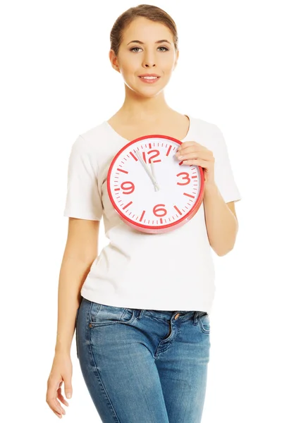 Woman holding a clock — Stock Photo, Image