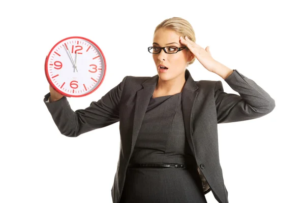 Businesswoman holding a big clock — Stock Photo, Image