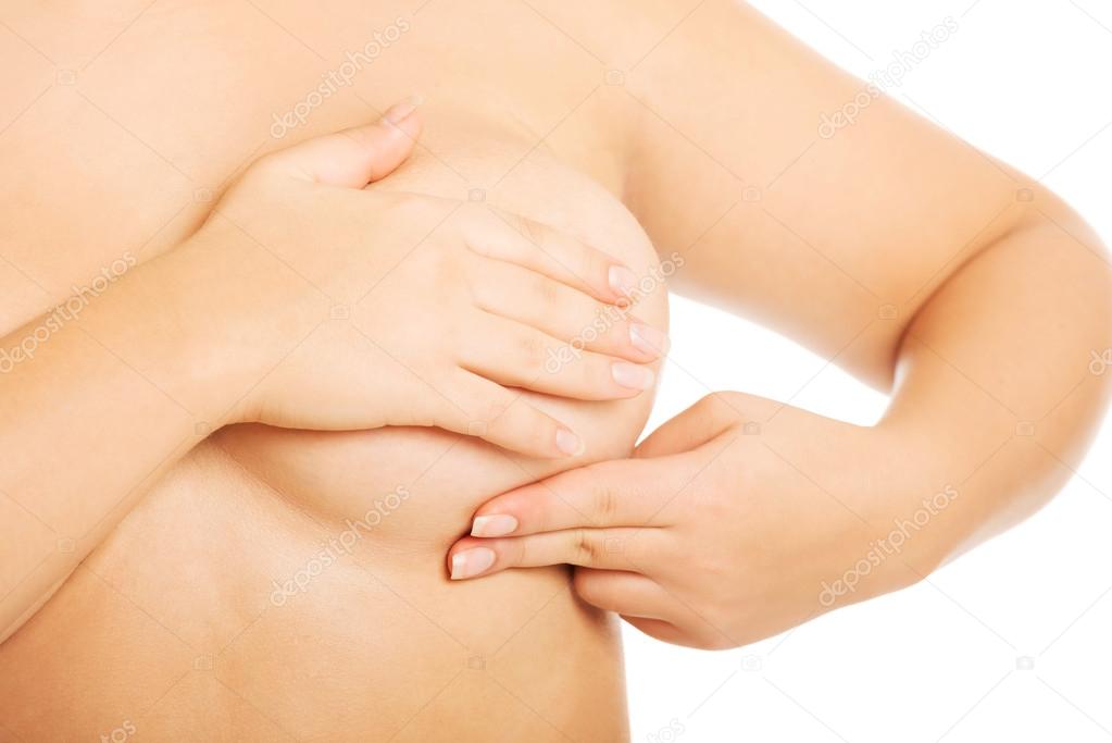 Overweight woman examining her breast.