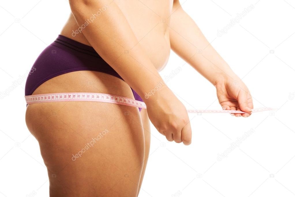 Fat woman measuting her bum.