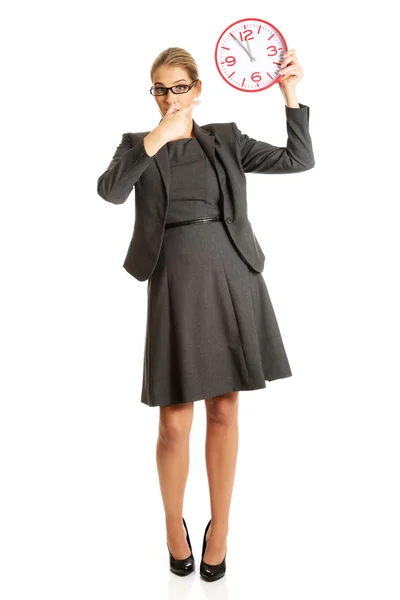 Businesswoman holding a big clock — Stock Photo, Image