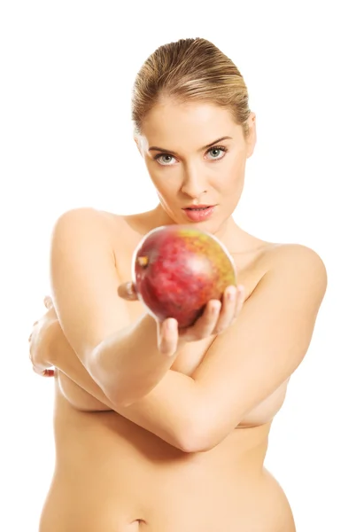 Nude woman giving a mango — Stock Photo, Image