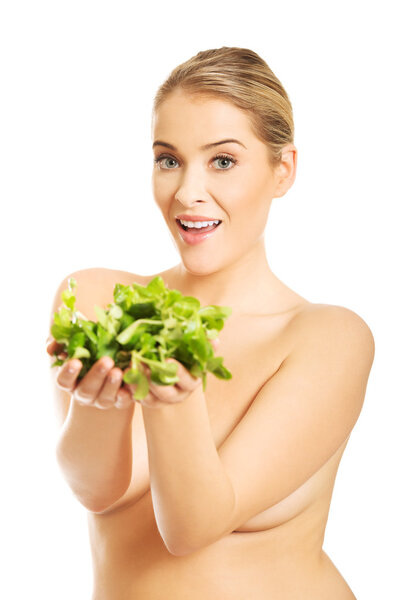 Nude woman giving lettuce