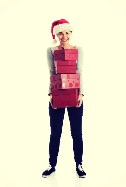 Beautifull woman in santa hat holding presents. — Stock Photo, Image