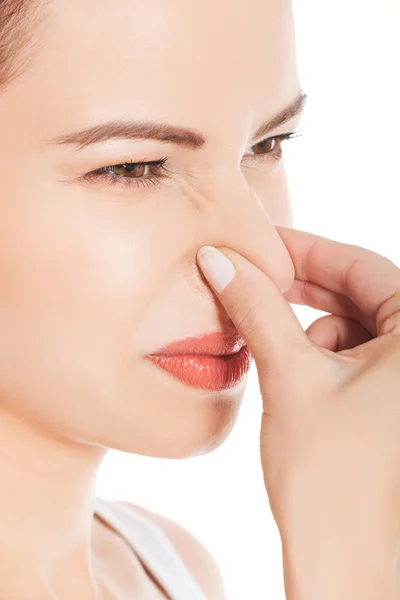 Mujer obstruyendo la nariz —  Fotos de Stock