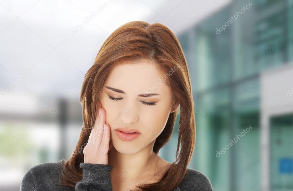 Woman having a terrible tooth ache.