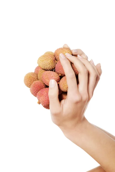 Hand holding lychees — Stock Photo, Image