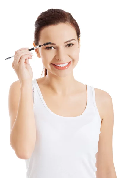 Mujer aplicando maquillaje —  Fotos de Stock