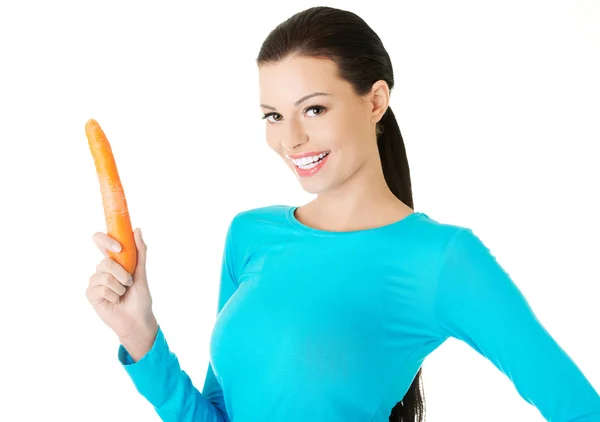 Woman holding a carrot — Stock Photo, Image