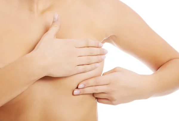 Close up nude woman examining her breast — Stock Photo, Image