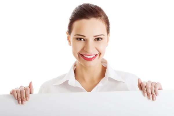 Happy woman holding white empty banner — Stock Photo, Image