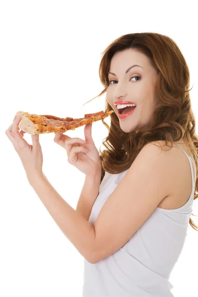Side view of a woman eating pizza — Stock Photo, Image