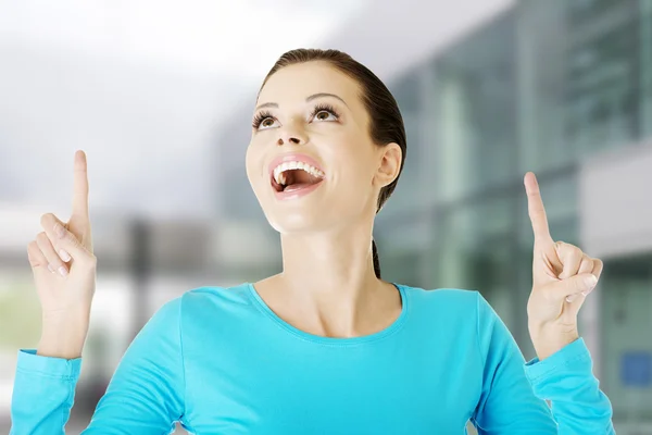 Young beautiful casual woman pointing up — Stock Photo, Image