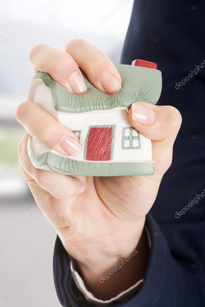 House model being squeezed in womans hand.