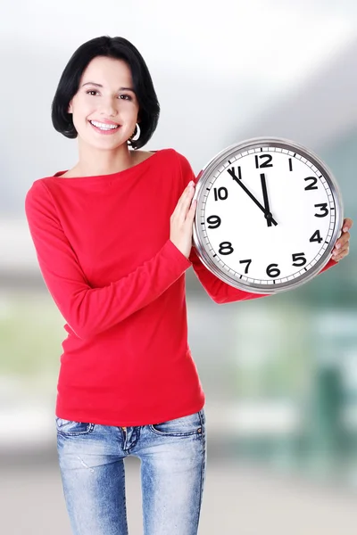 Happy young woman holding office clock — Stock Photo, Image