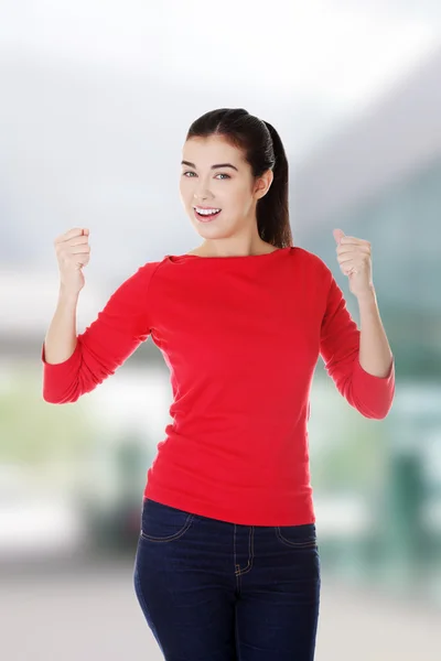 Excited young woman with fists up — Stock Photo, Image