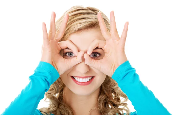 Woman showing ok sign on eyes Royalty Free Stock Photos