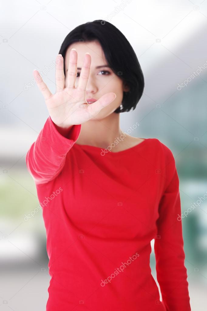 Confident woman making stop gesture