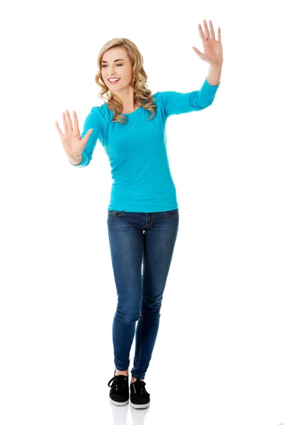Front view woman pulling imaginary screen — Stock Photo, Image
