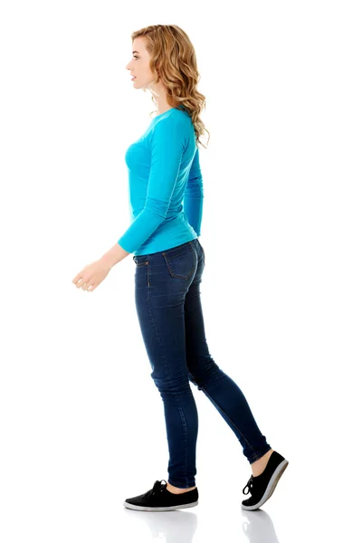 Side view of a woman walking slowly — Stock Photo, Image