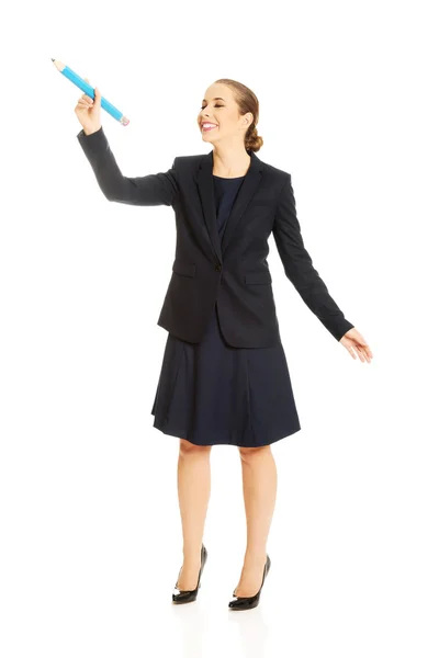 Businesswoman holding big pencil — Stock Photo, Image