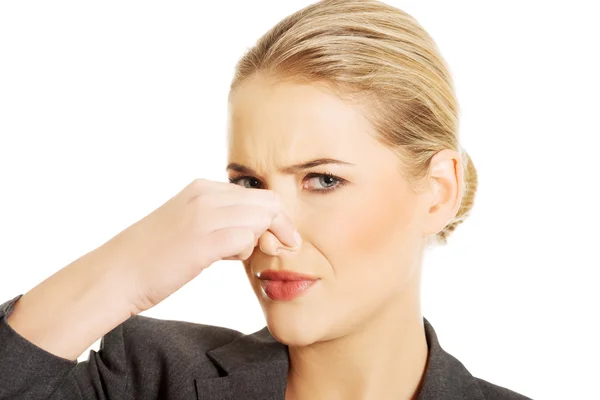 Woman pinching her nose — Stock Photo, Image