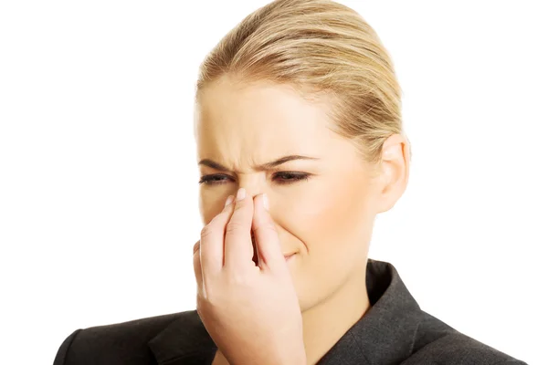 Woman pinching her nose — Stock Photo, Image