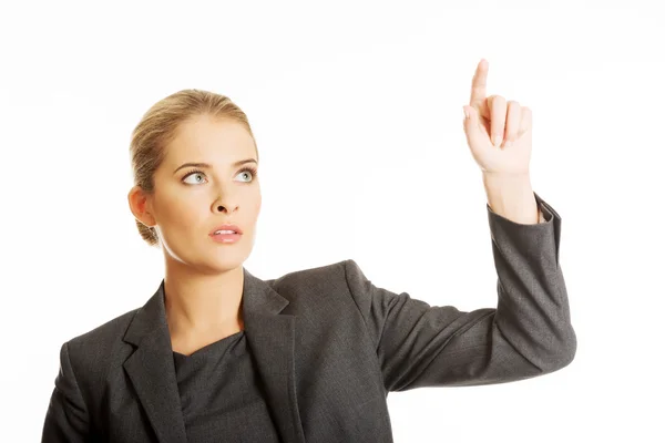 Businesswoman pressing an abstract button — Stock Photo, Image