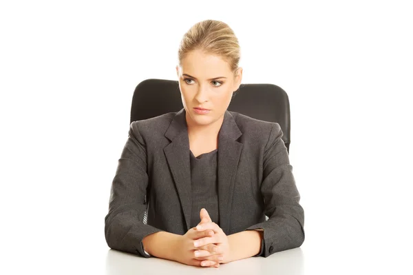 Smiling businesswoman sitting at the desk — Stock Photo, Image