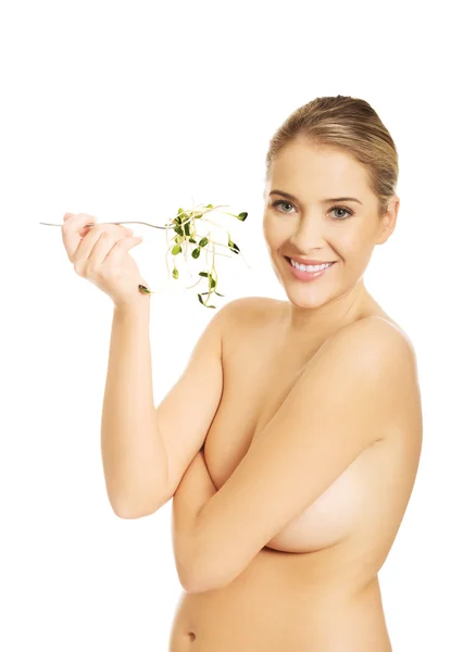 Woman holding a fork with cuckooflower — Stock Photo, Image