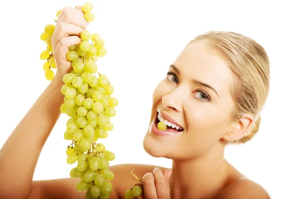 Nude woman eating grapes — Stock Photo, Image