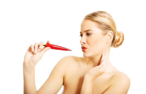 Nude woman eating chilli — Stock Photo, Image