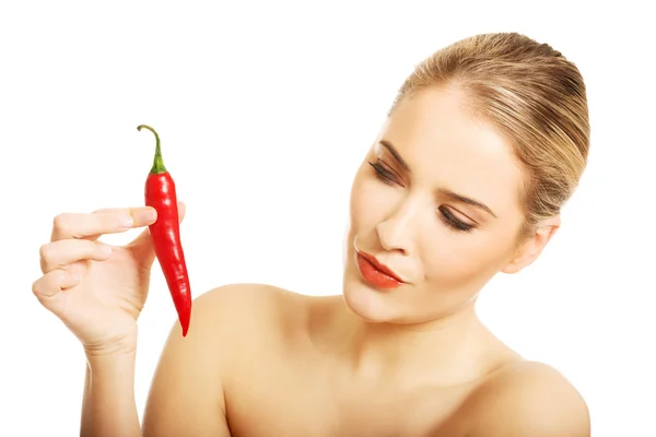 Nude woman eating chilli — Stock Photo, Image