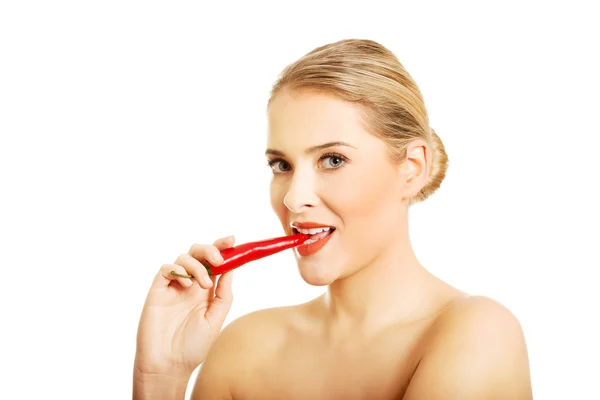 Nude woman eating chilli — Stock Photo, Image