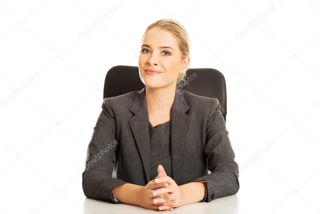 Smiling businesswoman sitting at the desk