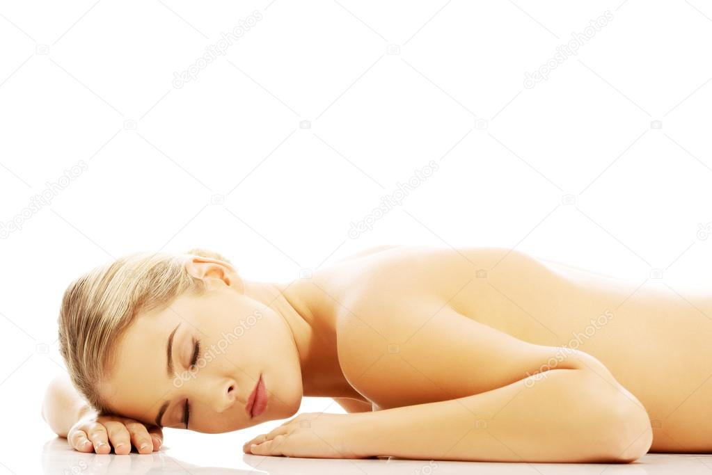 Nude woman lying on the floor