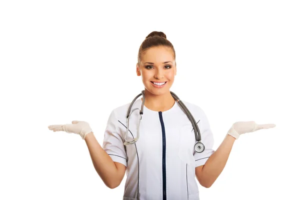 Female doctor presenting copyspace in both hands — Stock Photo, Image